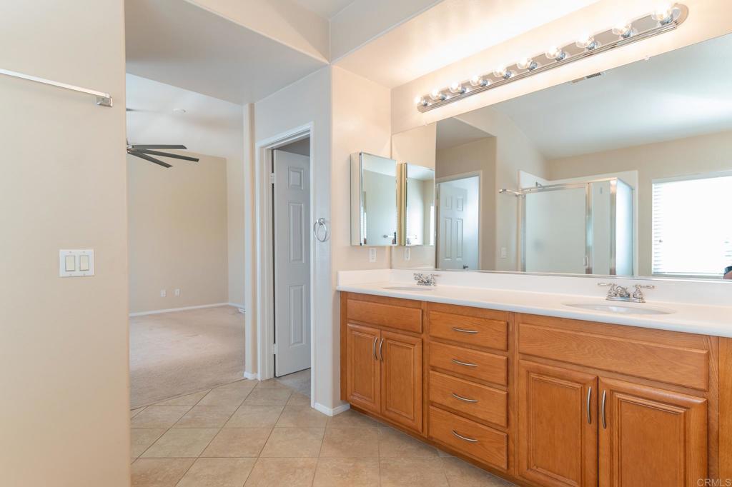 45160 Jumi Circle Temecula, CA 92592 - Photo 19 of 37 a spacious bathroom with a double vanity sink a mirror and a shower