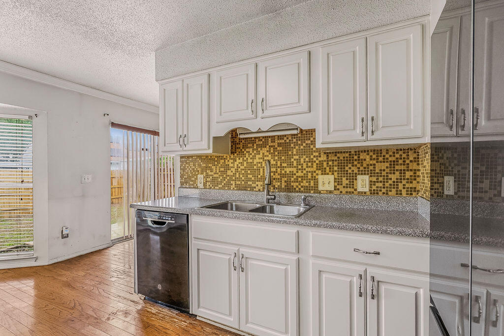 53 4th Street Shalimar, FL 32579 - Photo 13 of 47 a kitchen with stainless steel appliances granite countertop a sink and cabinets