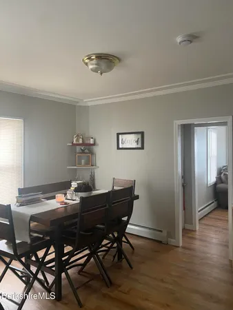 a view of a dining room with furniture and wooden floor