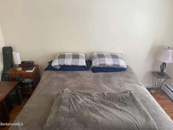 a bedroom with a bed and chair