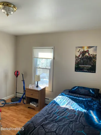 a bedroom with bed and a window