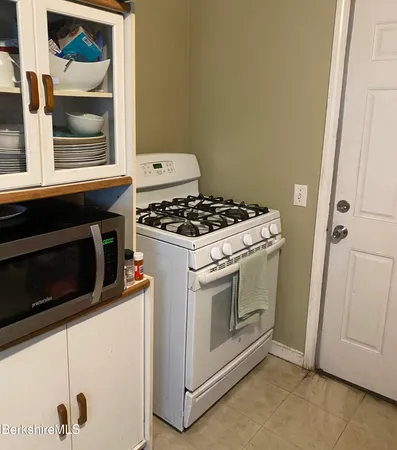 a stove top oven sitting inside of a kitchen