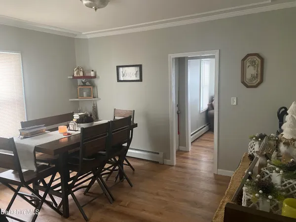 a view of a dining room with furniture and wooden floor