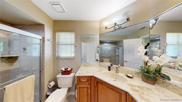 a bathroom with a granite countertop sink mirror and a bathtub