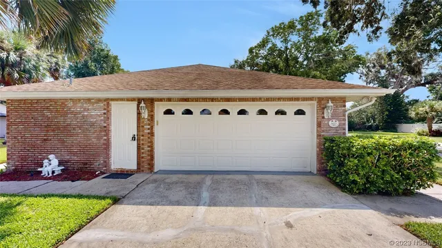 a view of a white house with a yard