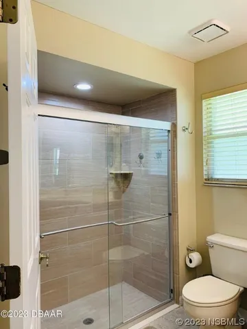 a bathroom with a toilet a shower and a sink