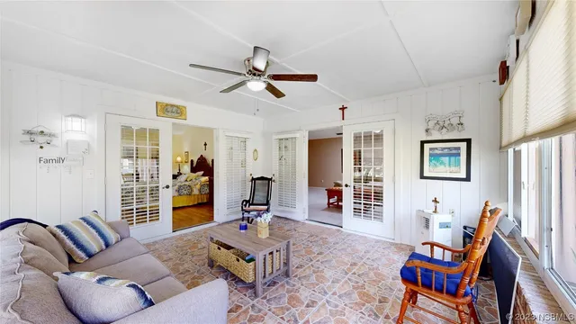 a living room with furniture a flat screen tv and a table