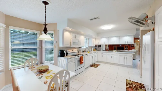 a kitchen with stainless steel appliances kitchen island granite countertop a sink and cabinets