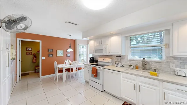 a kitchen that has a lot of cabinets in it and appliances