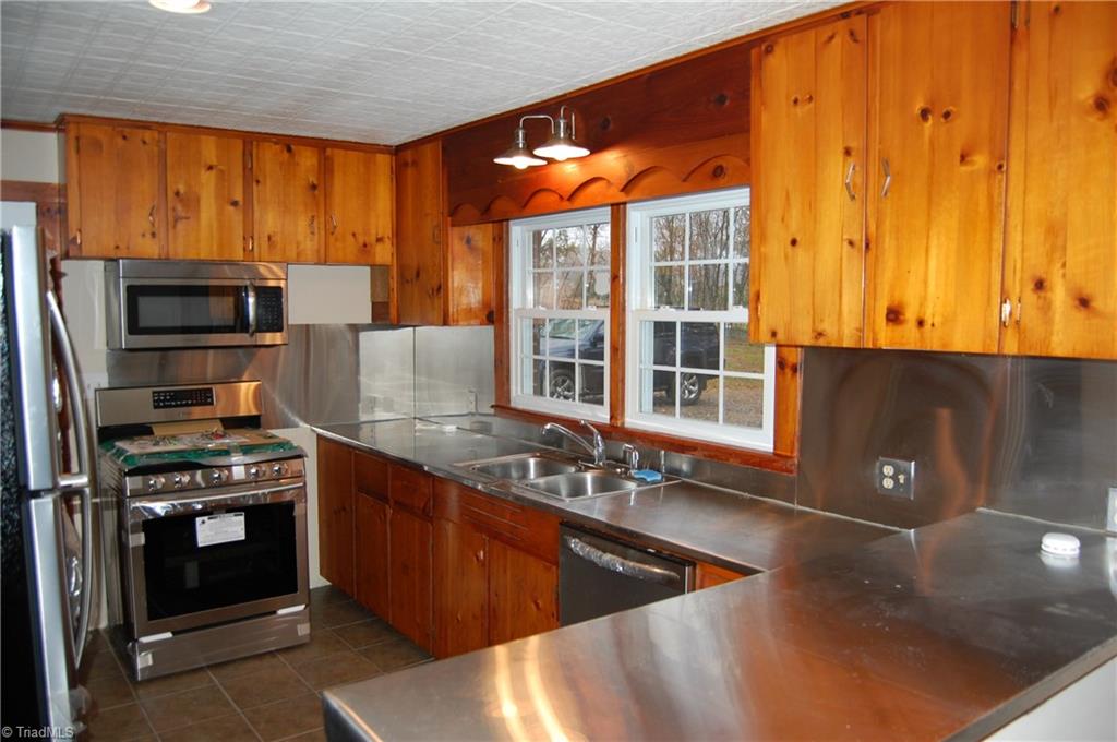 3224 Mining Ridge Church Road State Road, NC 28676 - Photo 14 of 26 NEW APPLIANCES , TILE FLOORS OPENS TO LIVING ROOM WITH WOOD BURNING FIRE PLACE.