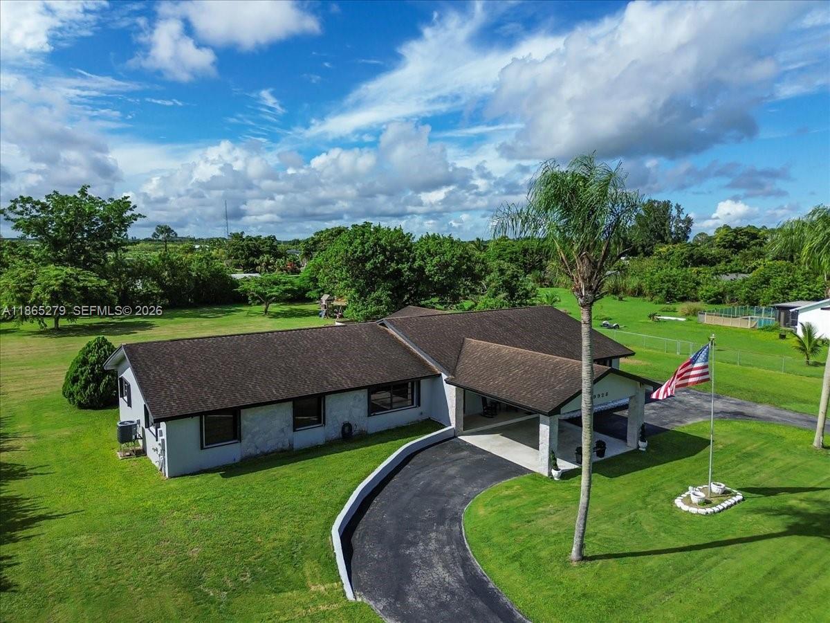 19926 Southwest 326th Street Homestead, FL 33030 - Photo 17 of 46 a aerial view of a house with a yard table and chairs