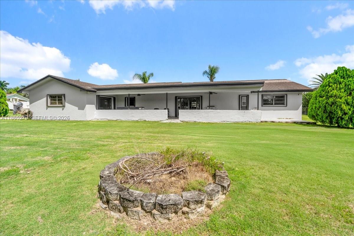 19926 Southwest 326th Street Homestead, FL 33030 - Photo 41 of 46 a front view of a house with a garden