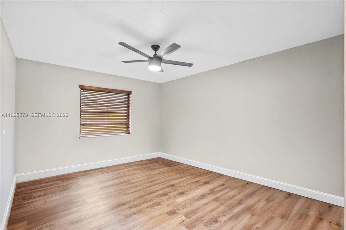 19926 Southwest 326th Street Homestead, FL 33030 - Photo 43 of 46 a view of a big room with wooden floor and windows
