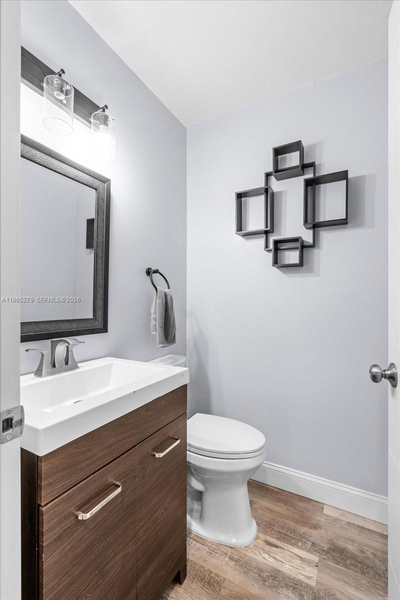 19926 Southwest 326th Street Homestead, FL 33030 - Photo 44 of 46 a bathroom with a toilet sink and mirror