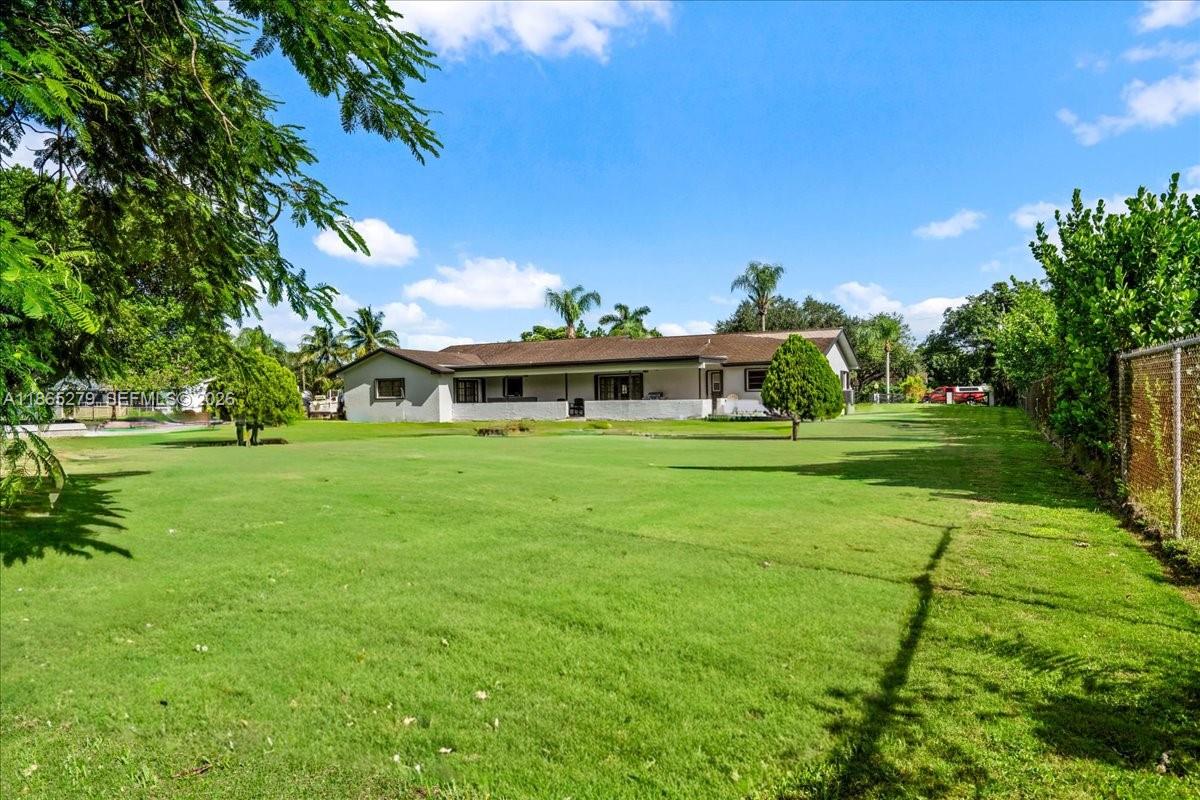 19926 Southwest 326th Street Homestead, FL 33030 - Photo 7 of 46 a view of a house with a big yard