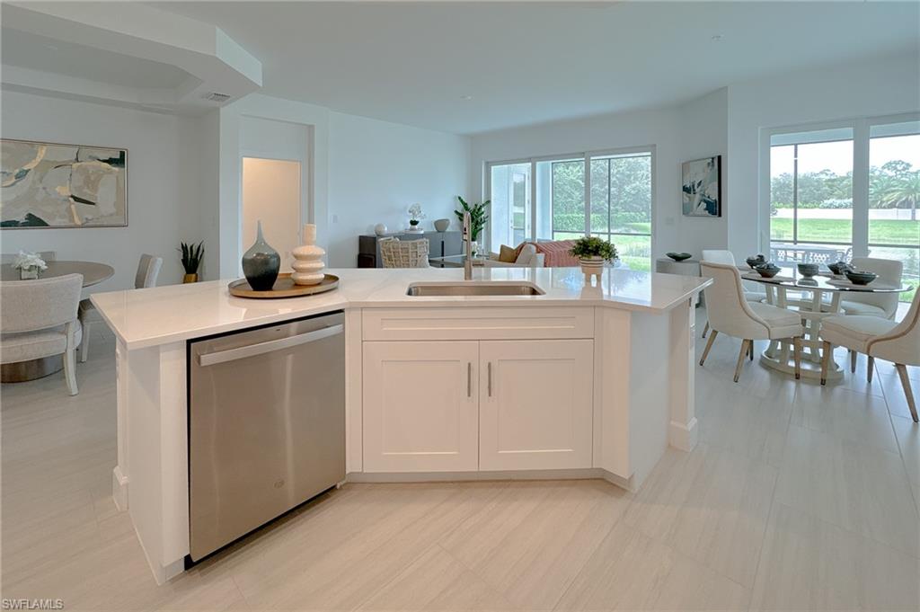 16881 Fairgrove Way, Unit 7102 Naples, FL 34110 - Photo 50 of 50 a open kitchen with white cabinets and white appliances