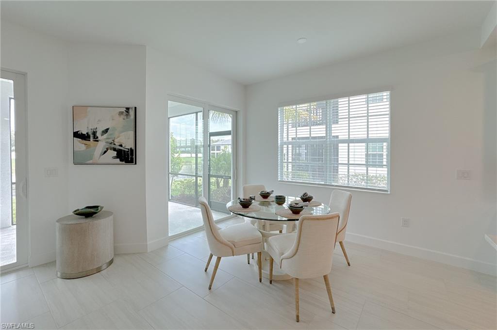 16881 Fairgrove Way, Unit 7102 Naples, FL 34110 - Photo 15 of 50 a dining room with furniture and window