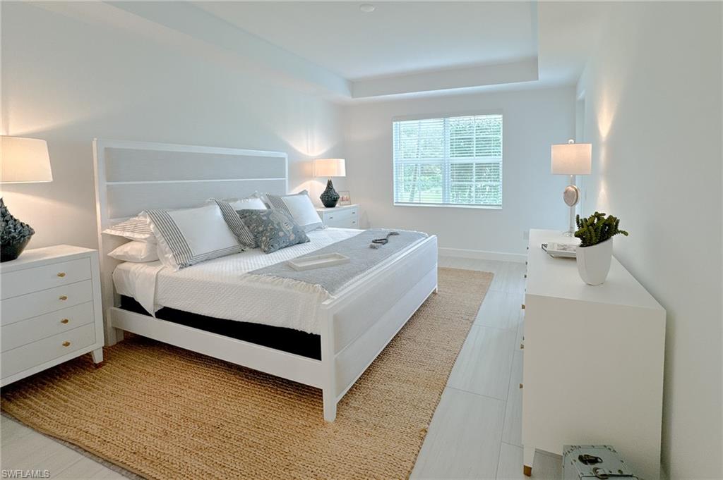 16881 Fairgrove Way, Unit 7102 Naples, FL 34110 - Photo 16 of 50 a bed room with a bed and a window