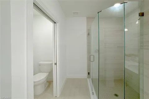 a bathroom with a double vanity sink a mirror and a shower