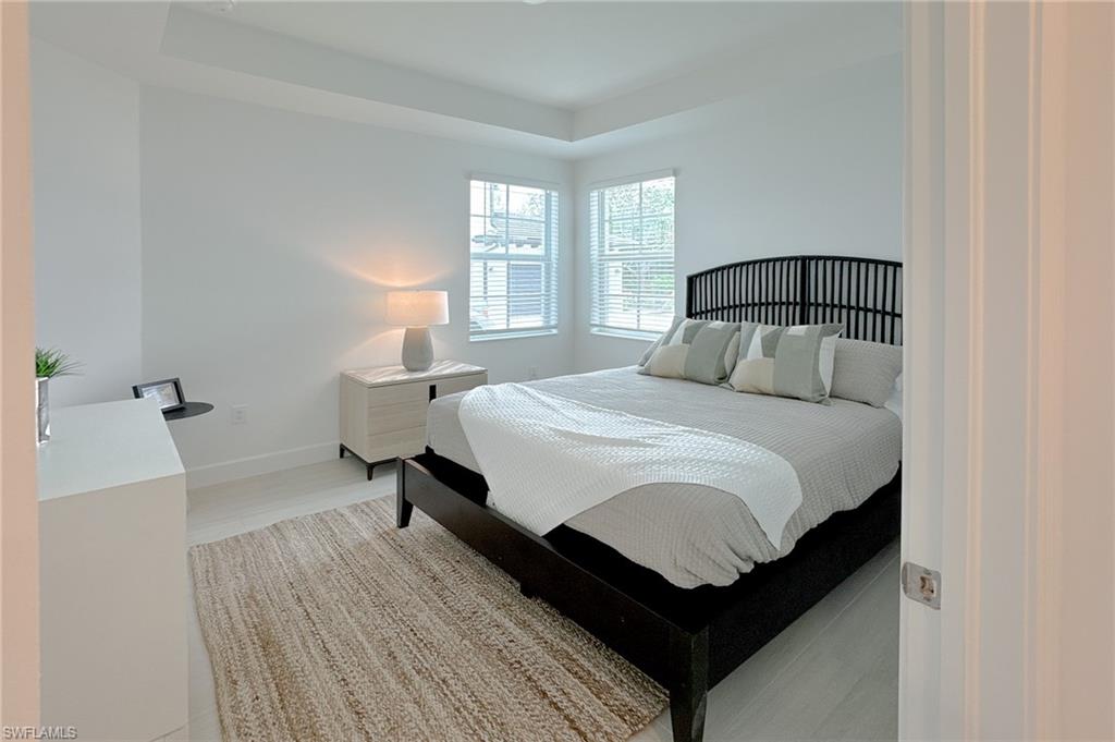 16881 Fairgrove Way, Unit 7102 Naples, FL 34110 - Photo 21 of 50 a bedroom with a bed and window