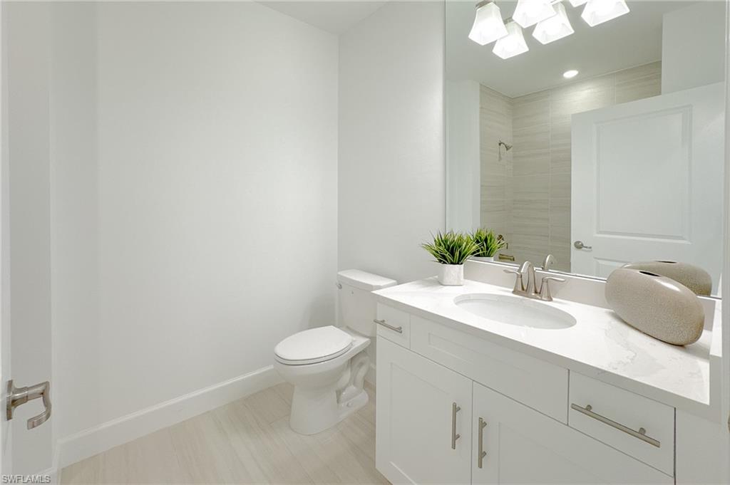 16881 Fairgrove Way, Unit 7102 Naples, FL 34110 - Photo 23 of 50 a bathroom with a sink a toilet and a mirror