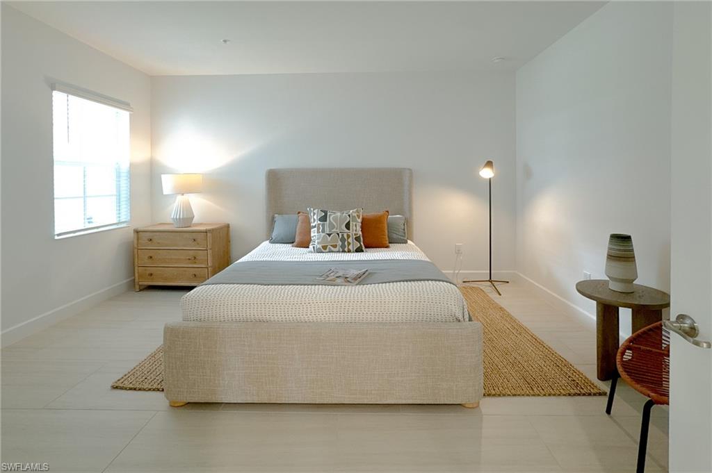 16881 Fairgrove Way, Unit 7102 Naples, FL 34110 - Photo 26 of 50 a bedroom with a bed and window