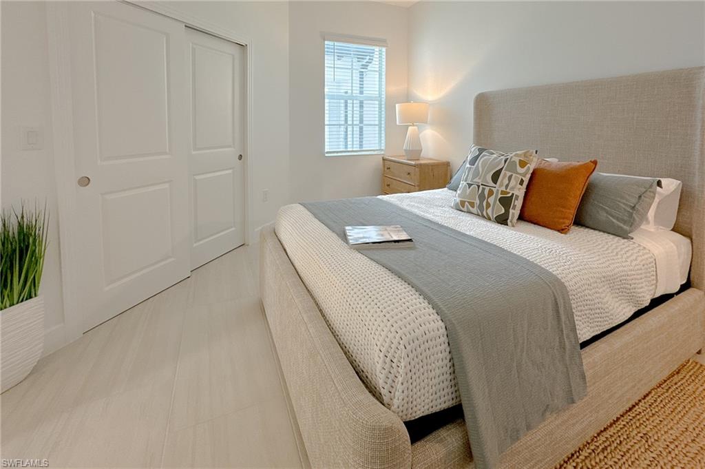 16881 Fairgrove Way, Unit 7102 Naples, FL 34110 - Photo 27 of 50 a bedroom with a bed and a window