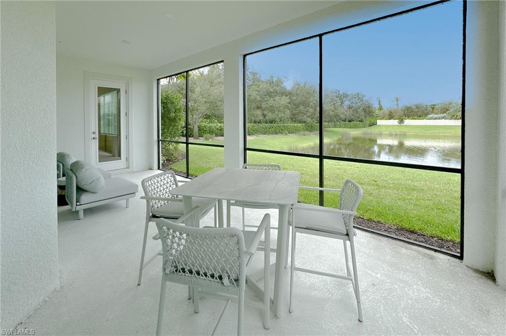 16881 Fairgrove Way, Unit 7102 Naples, FL 34110 - Photo 29 of 50 a view of a room with a large window and chairs