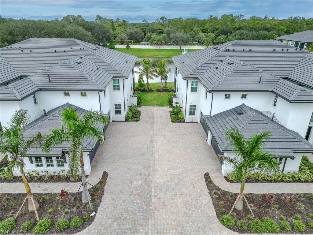 16881 Fairgrove Way, Unit 7102 Naples, FL 34110 - Photo 35 of 50 a aerial view of a house with a yard and potted plants