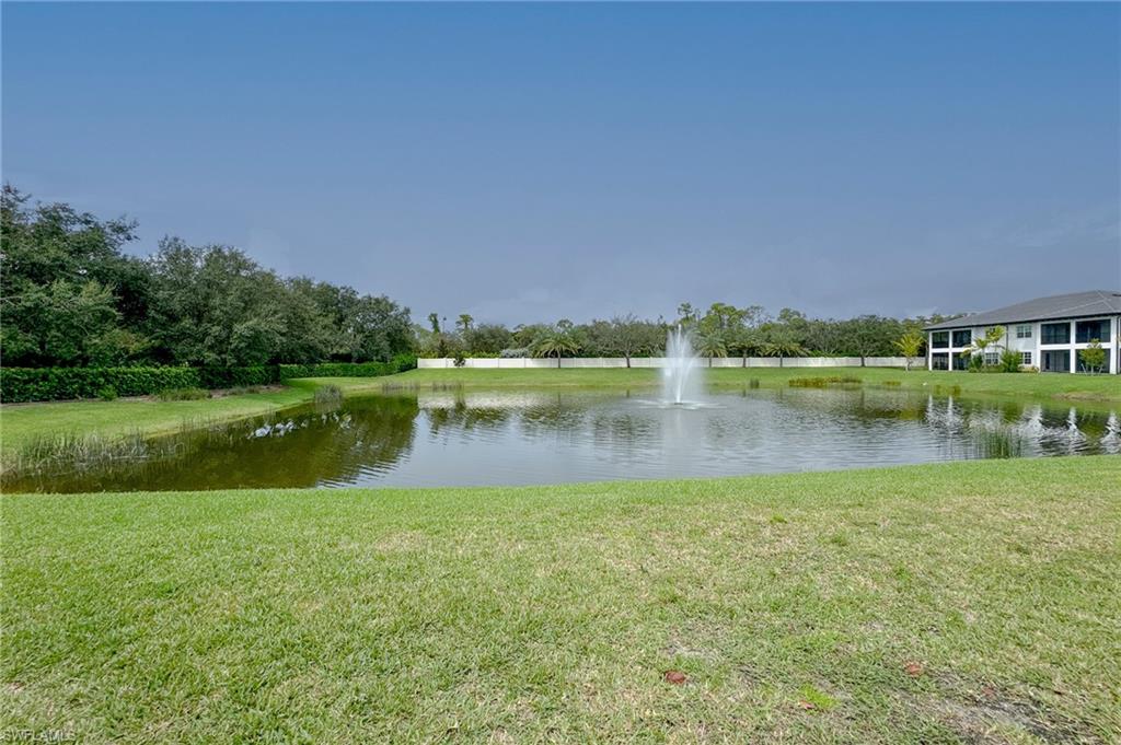 16881 Fairgrove Way, Unit 7102 Naples, FL 34110 - Photo 36 of 50 a view of lake with green space