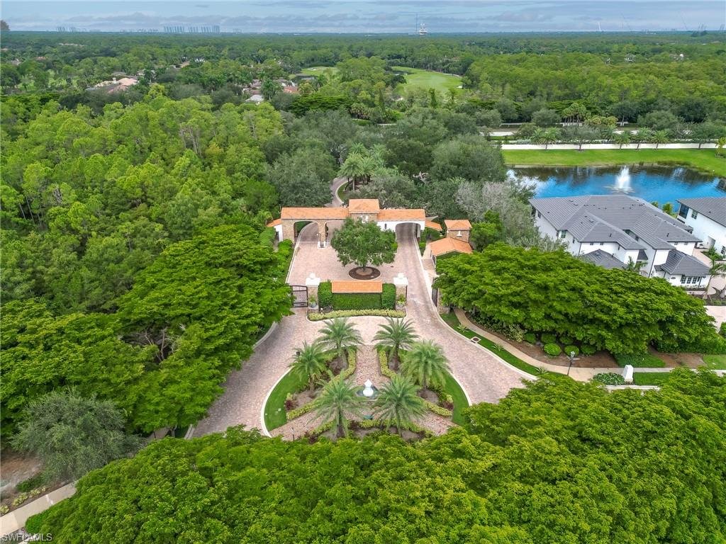 16881 Fairgrove Way, Unit 7102 Naples, FL 34110 - Photo 46 of 50 an aerial view of a house with a garden