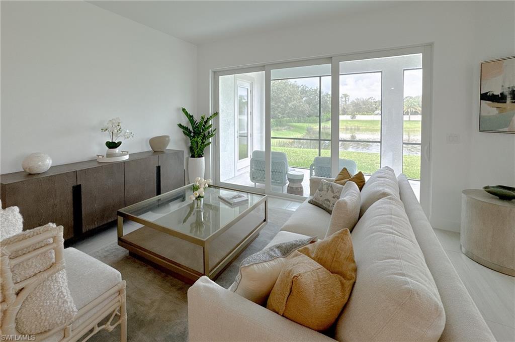 16881 Fairgrove Way, Unit 7102 Naples, FL 34110 - Photo 7 of 50 a living room with furniture and a large window
