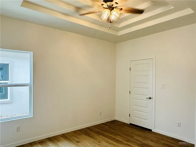 a view of a room with wooden floor and closet area