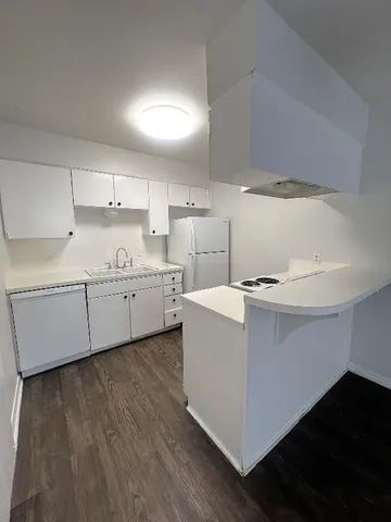 a view of a kitchen with wooden floor