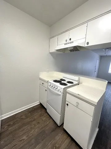 a view of washer and dryer with wooden cabinets