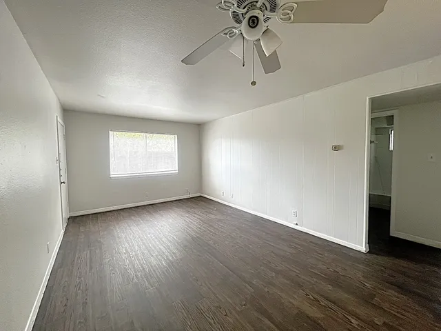 wooden floor in an empty room with a window
