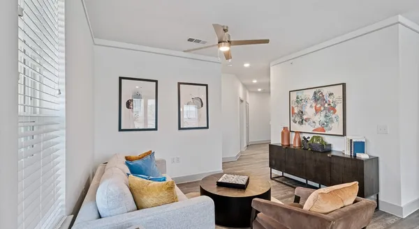 a living room with furniture a rug and a window
