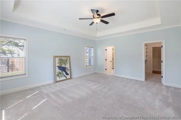 a view of a livingroom with a ceiling fan and window