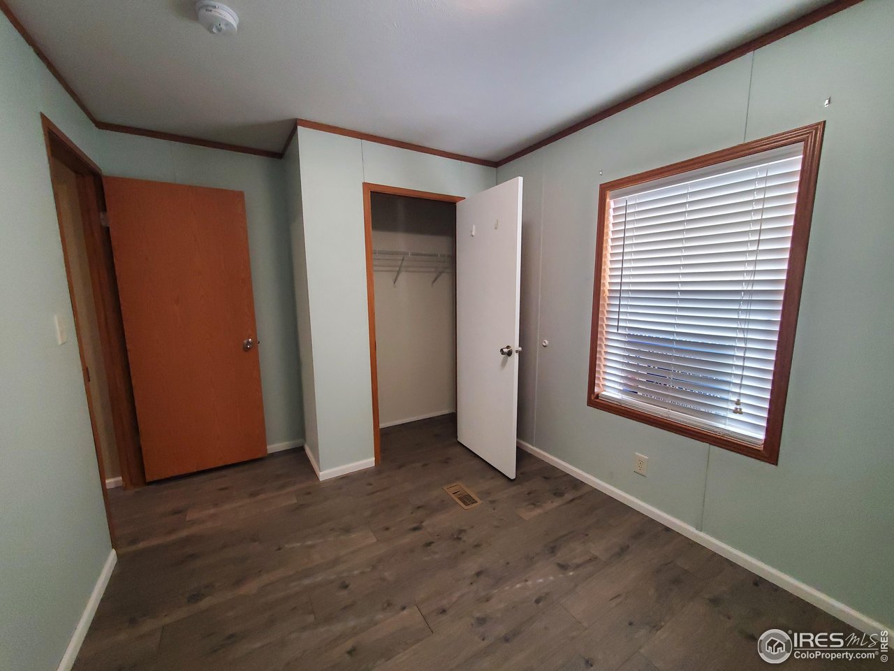 3717 South Taft Hill Road, Unit 285 Fort Collins, CO 80526 - Photo 17 of 18 an empty room with wooden floor and windows