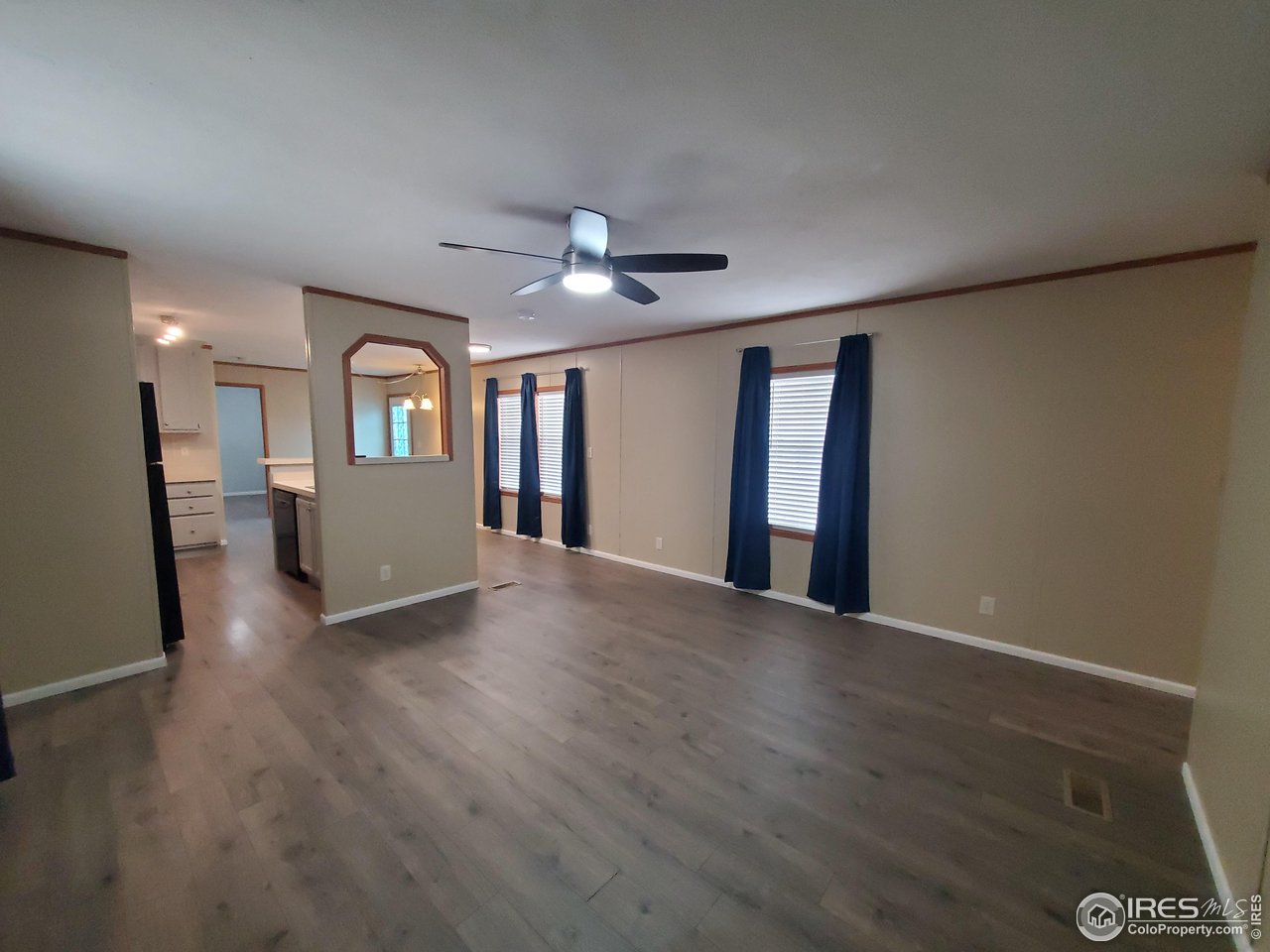 3717 South Taft Hill Road, Unit 285 Fort Collins, CO 80526 - Photo 2 of 18 a view of an empty room with a window and wooden floor