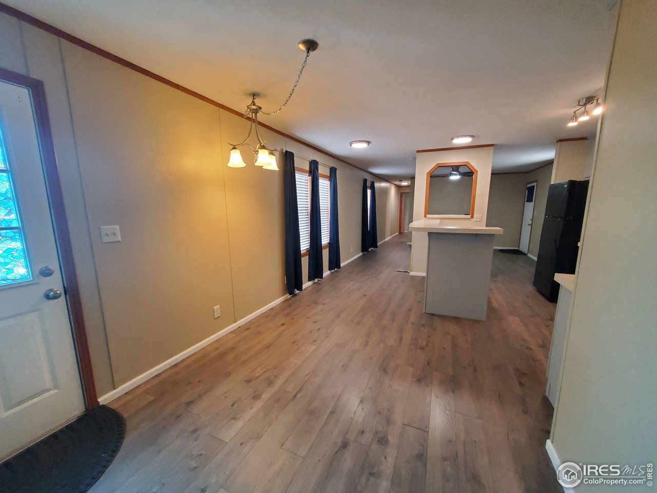 3717 South Taft Hill Road, Unit 285 Fort Collins, CO 80526 - Photo 4 of 18 a view of a hallway with wooden floor