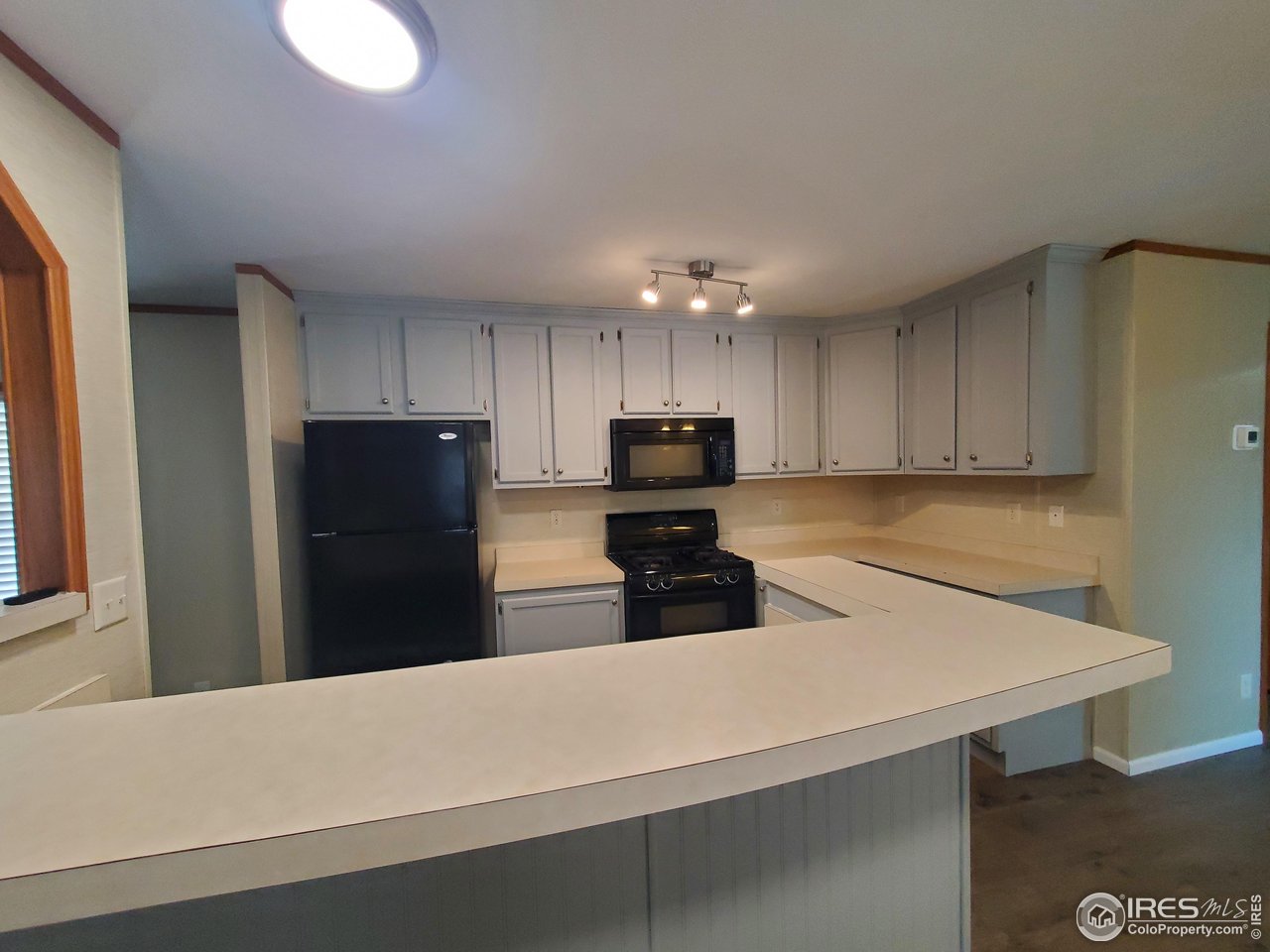 3717 South Taft Hill Road, Unit 285 Fort Collins, CO 80526 - Photo 5 of 18 a kitchen with a refrigerator a sink and a stove top oven