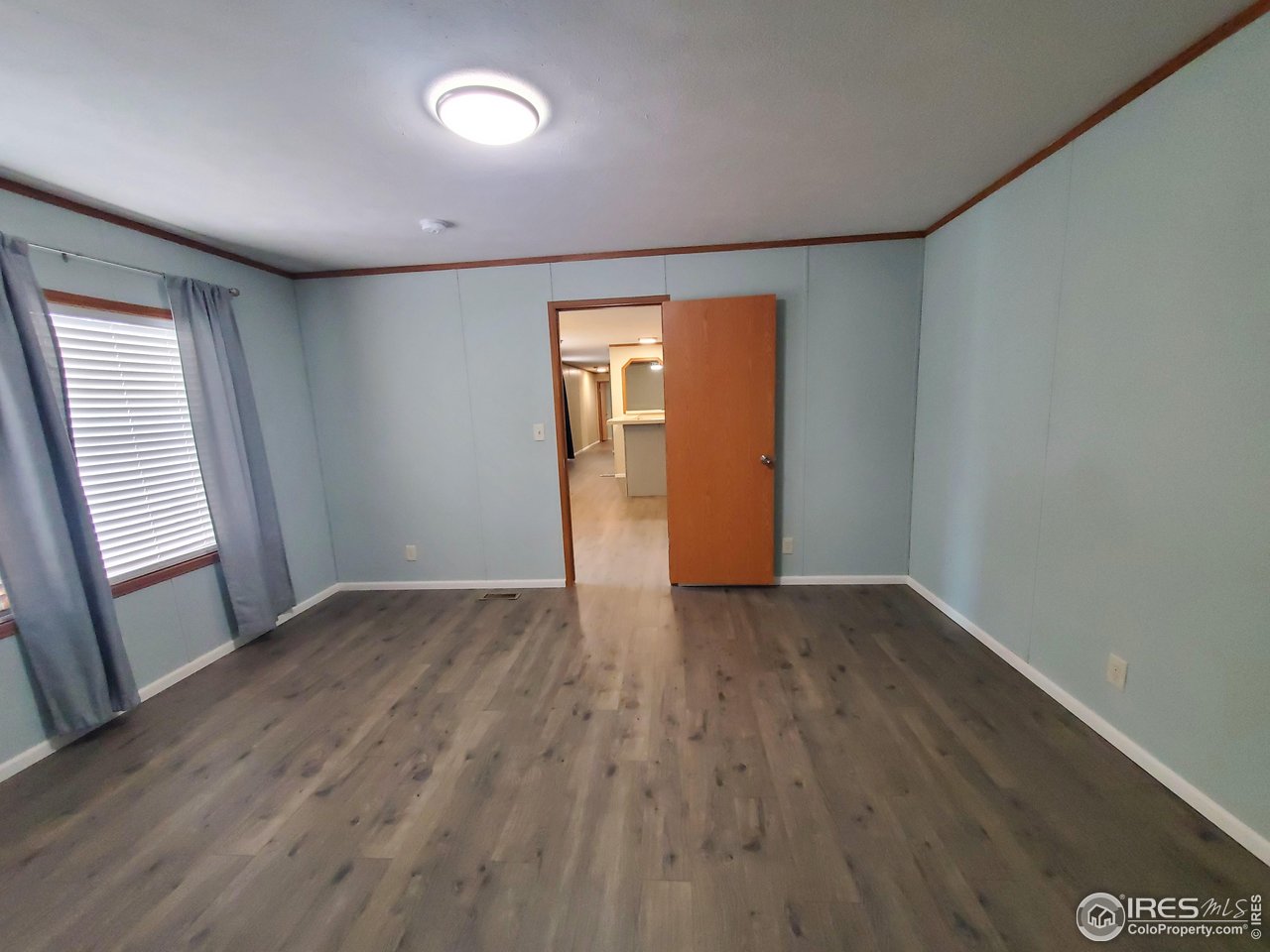 3717 South Taft Hill Road, Unit 285 Fort Collins, CO 80526 - Photo 8 of 18 an empty room with wooden floor and windows