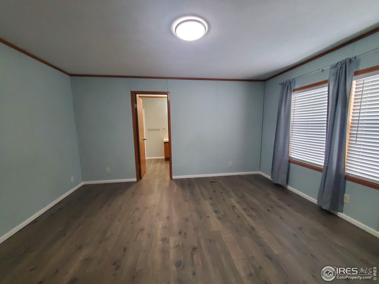 3717 South Taft Hill Road, Unit 285 Fort Collins, CO 80526 - Photo 9 of 18 an empty room with wooden floor and windows
