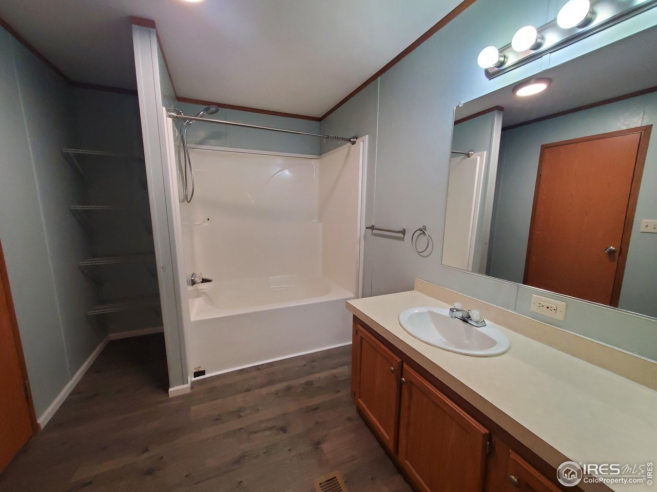 3717 South Taft Hill Road, Unit 285 Fort Collins, CO 80526 - Photo 10 of 18 a bathroom with a sink vanity granite tub shower and a mirror