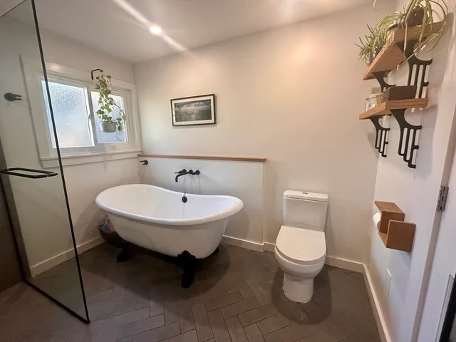 a bathroom with a toilet sink and mirror