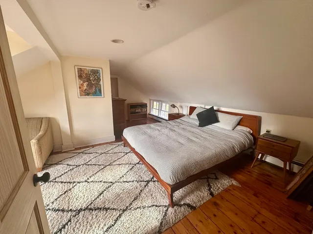a living room with furniture rug and wooden floor