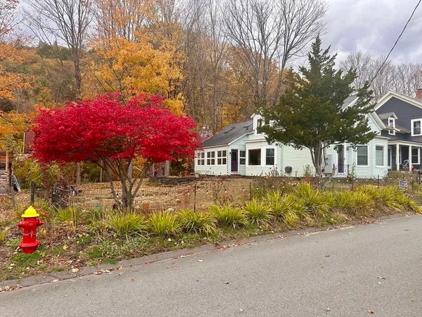 a front view of a house with yard and garage