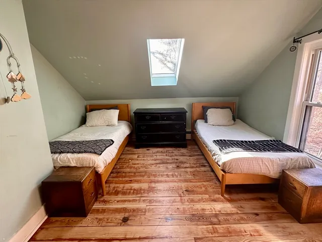 a view of a kitchen with furniture and wooden floor