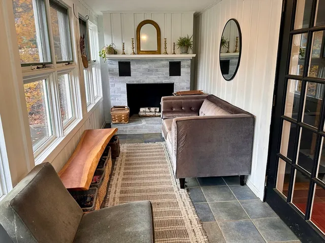 a kitchen with stainless steel appliances granite countertop a refrigerator a sink dishwasher a stove and a dining table with wooden floor